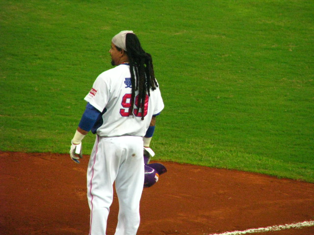a baseball player on the field wearing all white