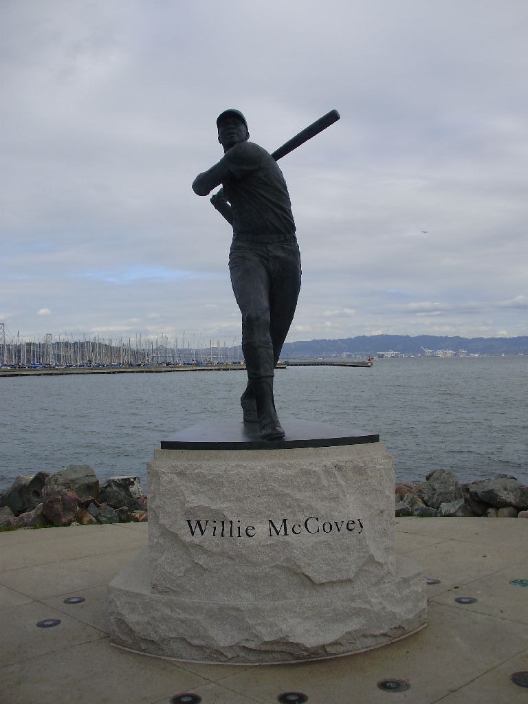 a statue of the baseball player who has fallen under his arm