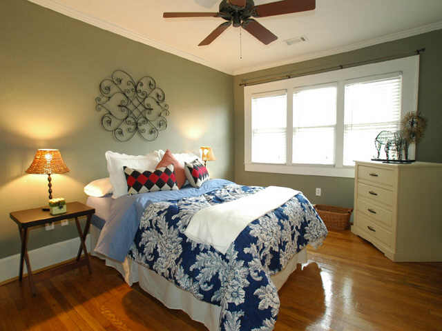 a clean bedroom decorated with pillows and a large bed