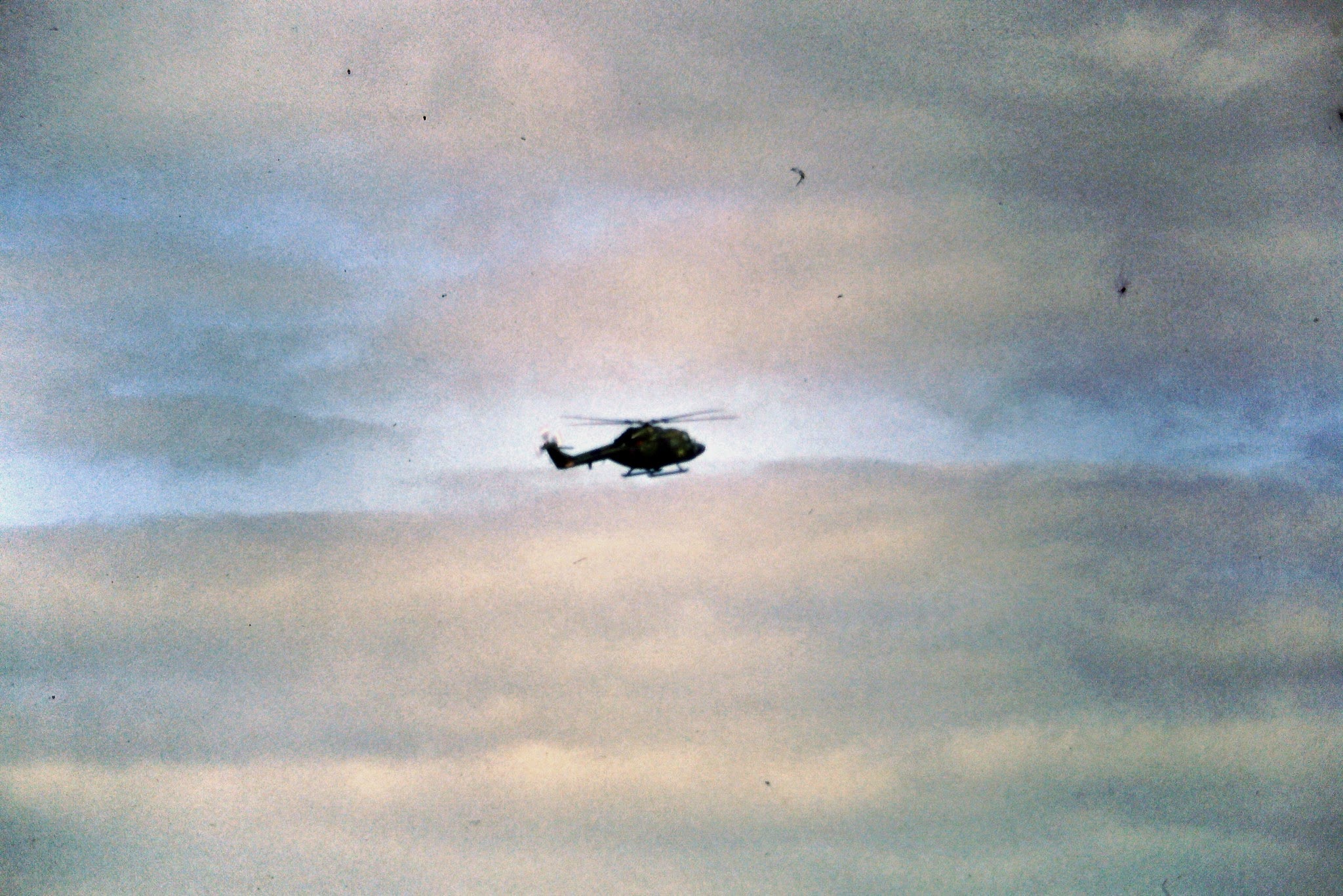 a helicopter flying through the cloudy sky