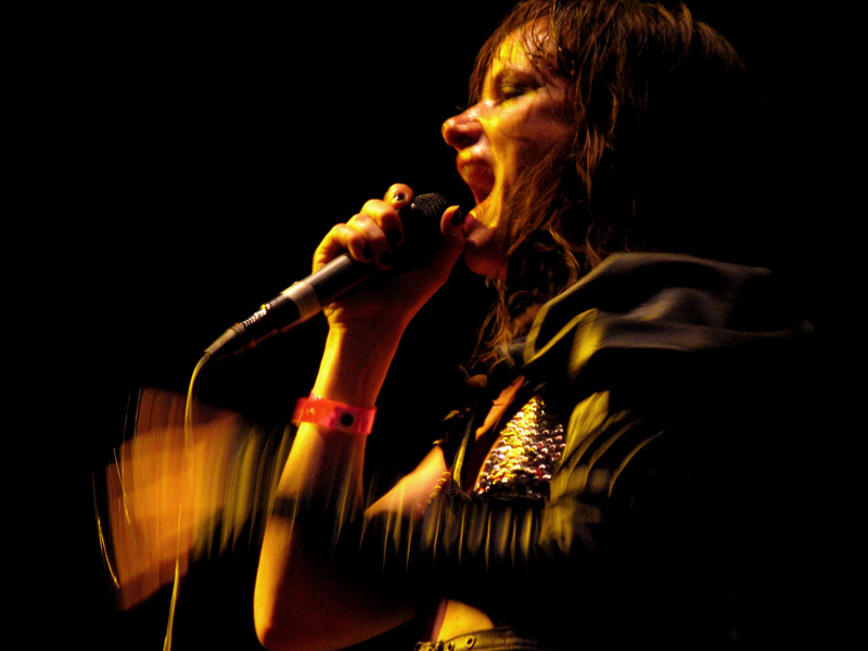 a person standing with a microphone on a stage