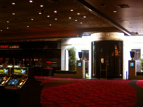 a red carpet and a casino machine with various slot machines