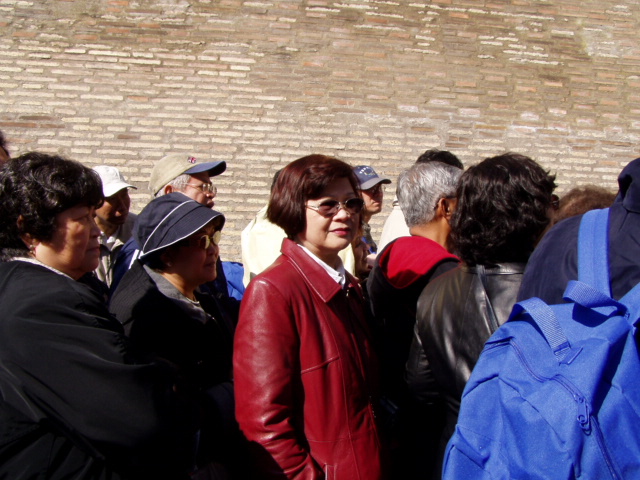 a group of people stand together against a brick wall