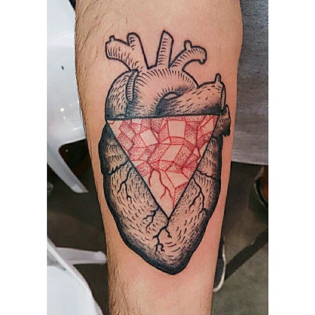 a tattoo with an heart that has a red diamond