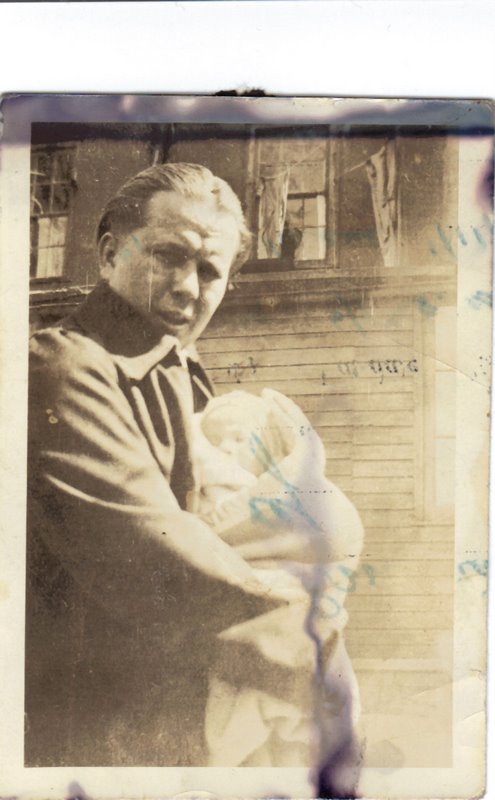 a man in a suit holding a baby