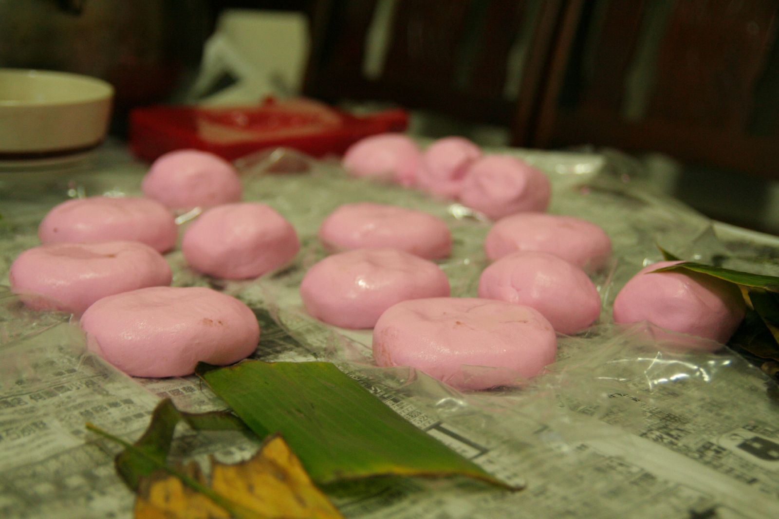 a table with donuts that are pink and some green