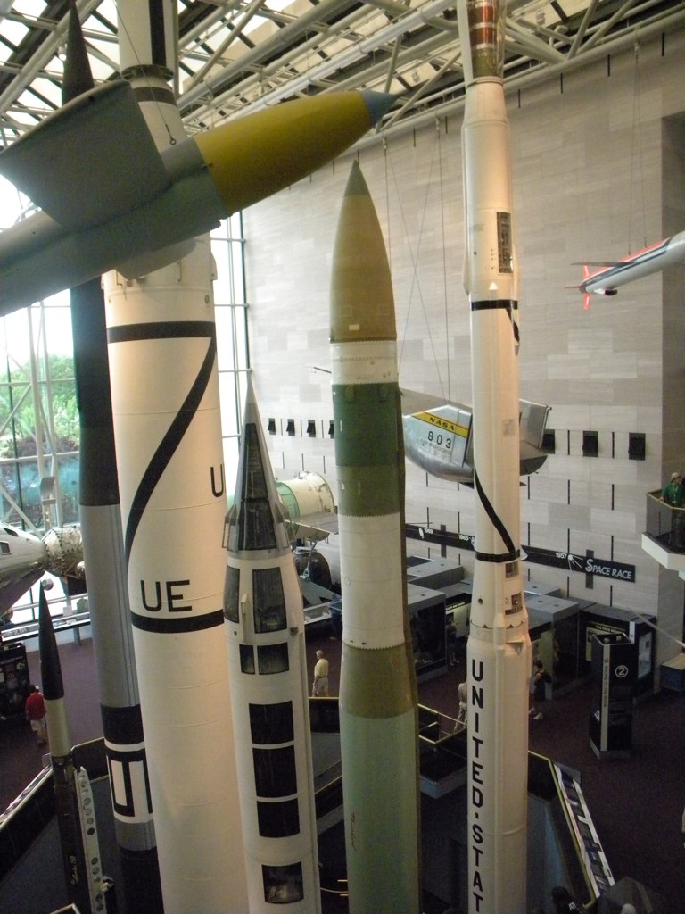 many white and green rockets sitting in the middle of a building