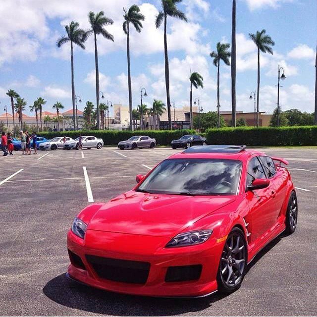 red sports car in an empty parking lot