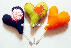 three cute little colorful hearts on sticks