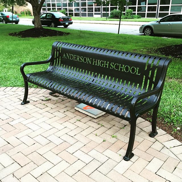a bench that is sitting on a brick walkway