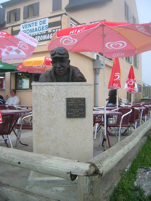 a small monument with an umbrella over it