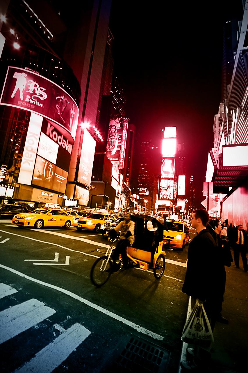 people walking and riding their bicycles in the night