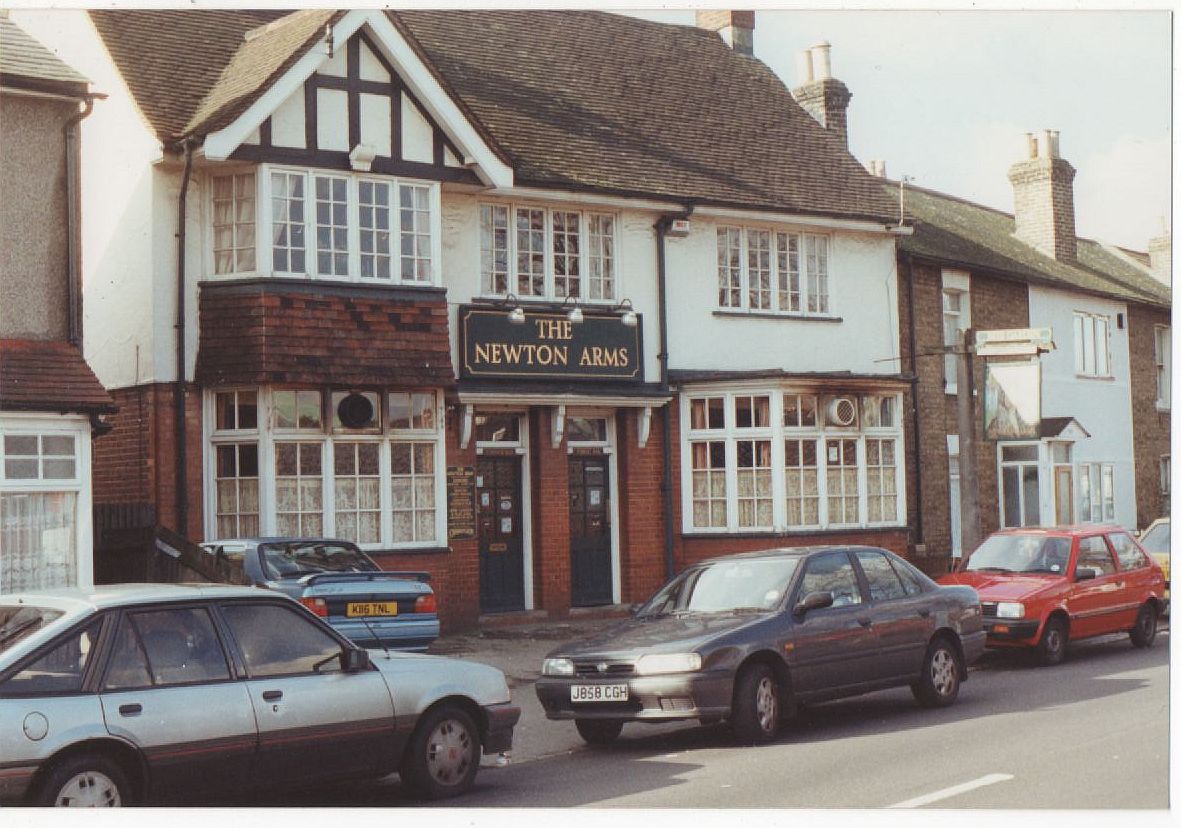 cars parked on a street near a pub