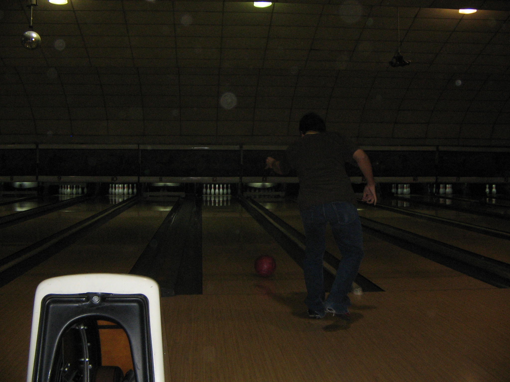 a man riding a skateboard down a wooden floor