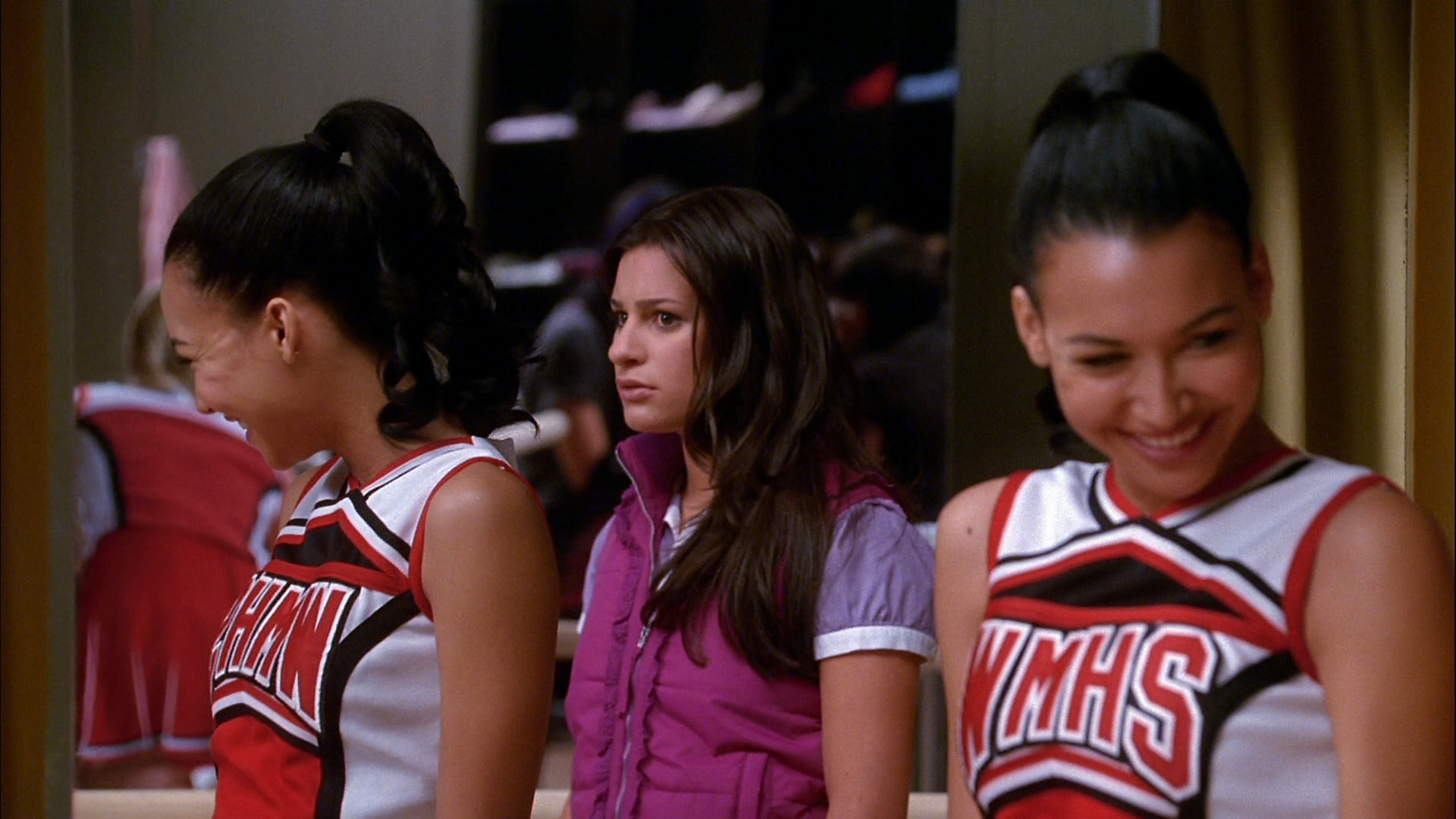 three women who are dressed in cheerleader uniforms