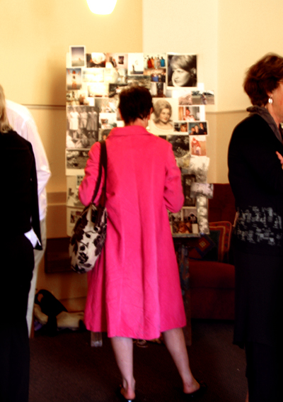 three ladies are standing in line in a museum gallery