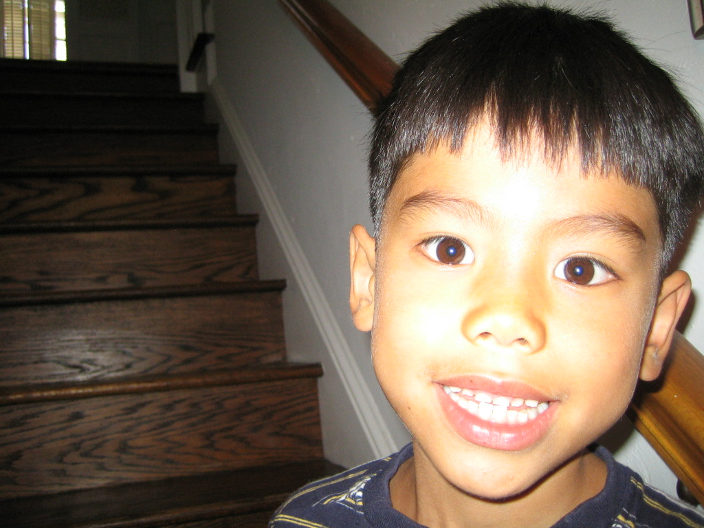 the  smiles in front of a stairwell with stair tread