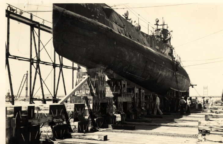 a ship sitting on dry dock in an old pograph