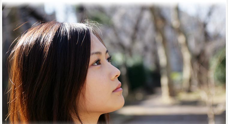 a woman with long brown hair is looking away from the camera