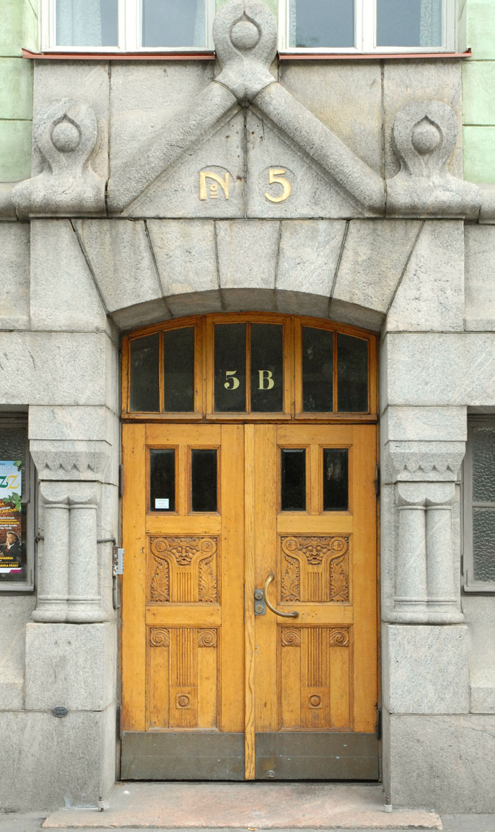 a large wood door on the front of an old building