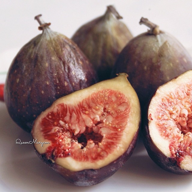 some figs are sitting on a white table