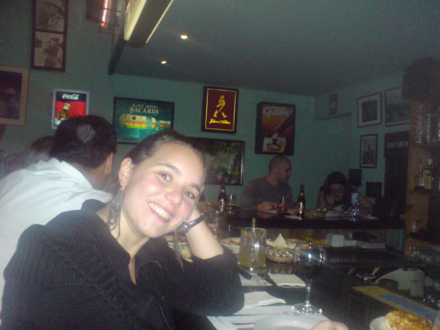 a woman sitting in a restaurant smiling