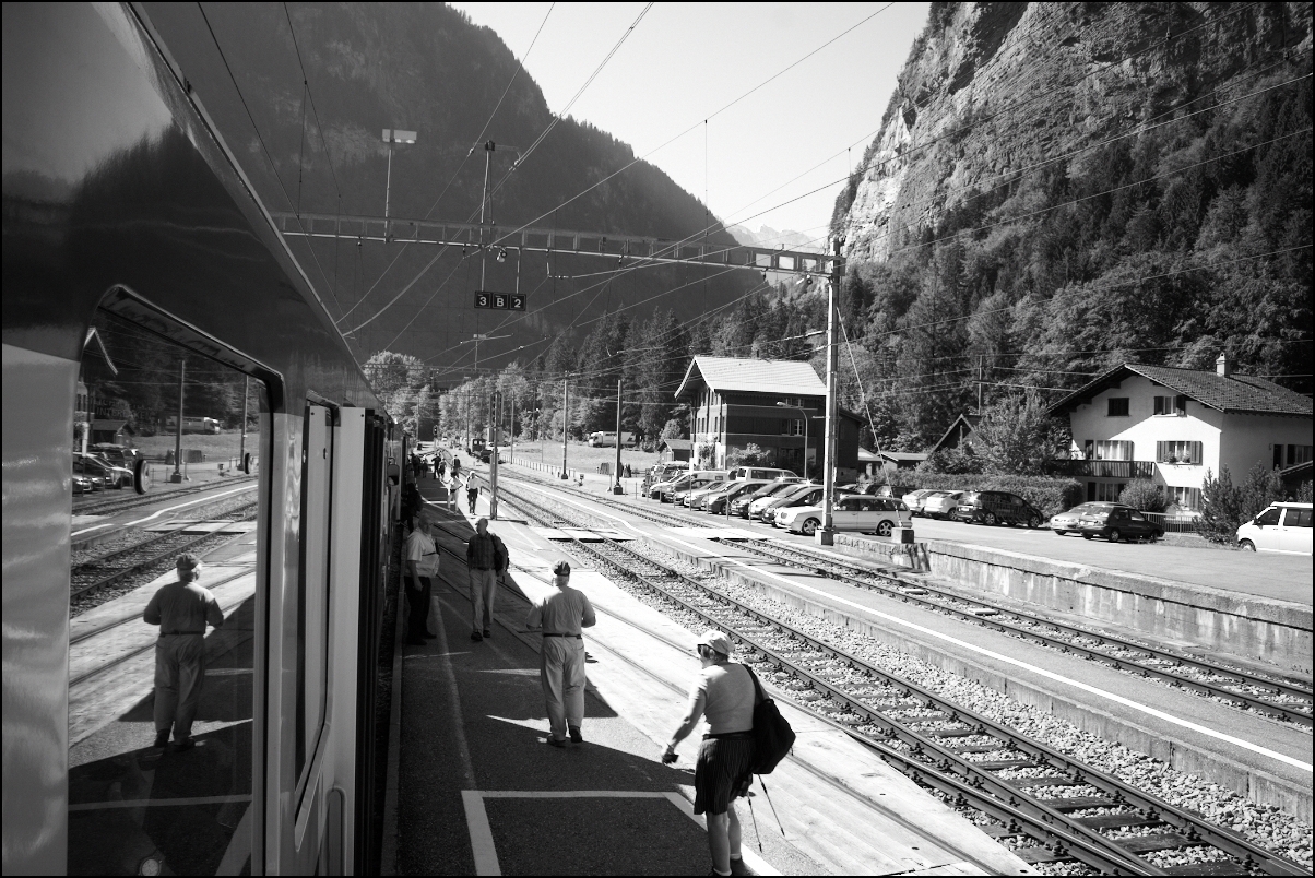 a group of people at a railway station with some of the trains