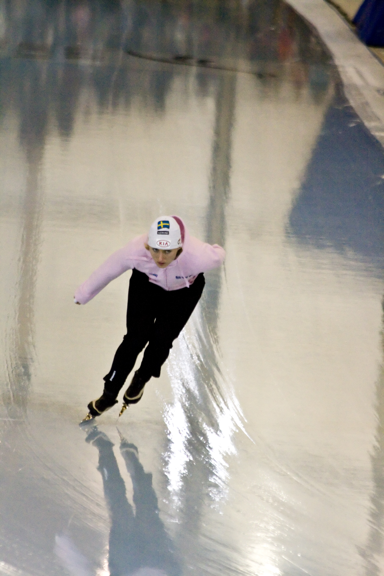 a person skating down a hill in a snow suit