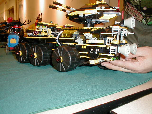 a man is sitting in front of a toy vehicle