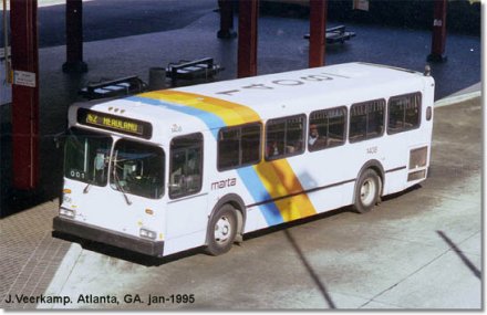 a white bus parked next to a red street sign