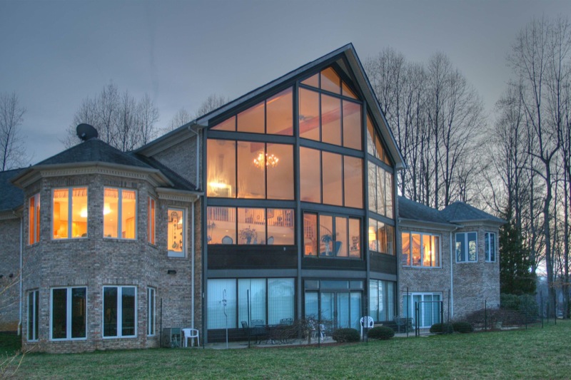 a beautiful home is illuminated with orange lights