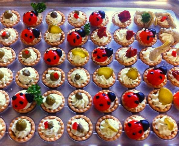 cupcakes in the shape of ladybugs are arranged on a tray