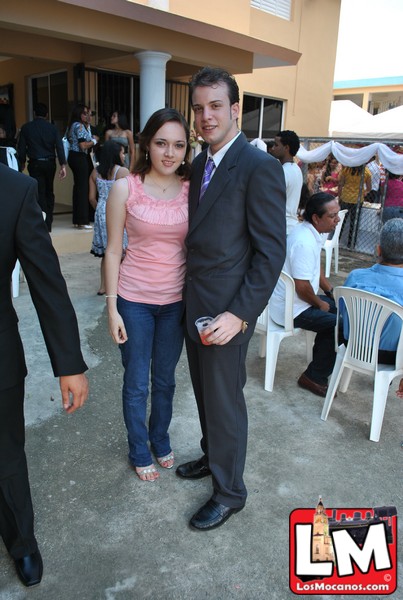two young people dressed in business attire standing together