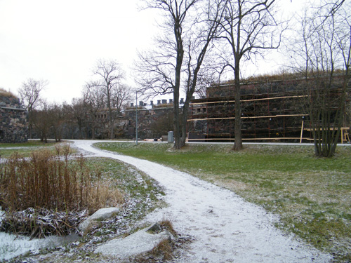the park has a walkway and a brick building