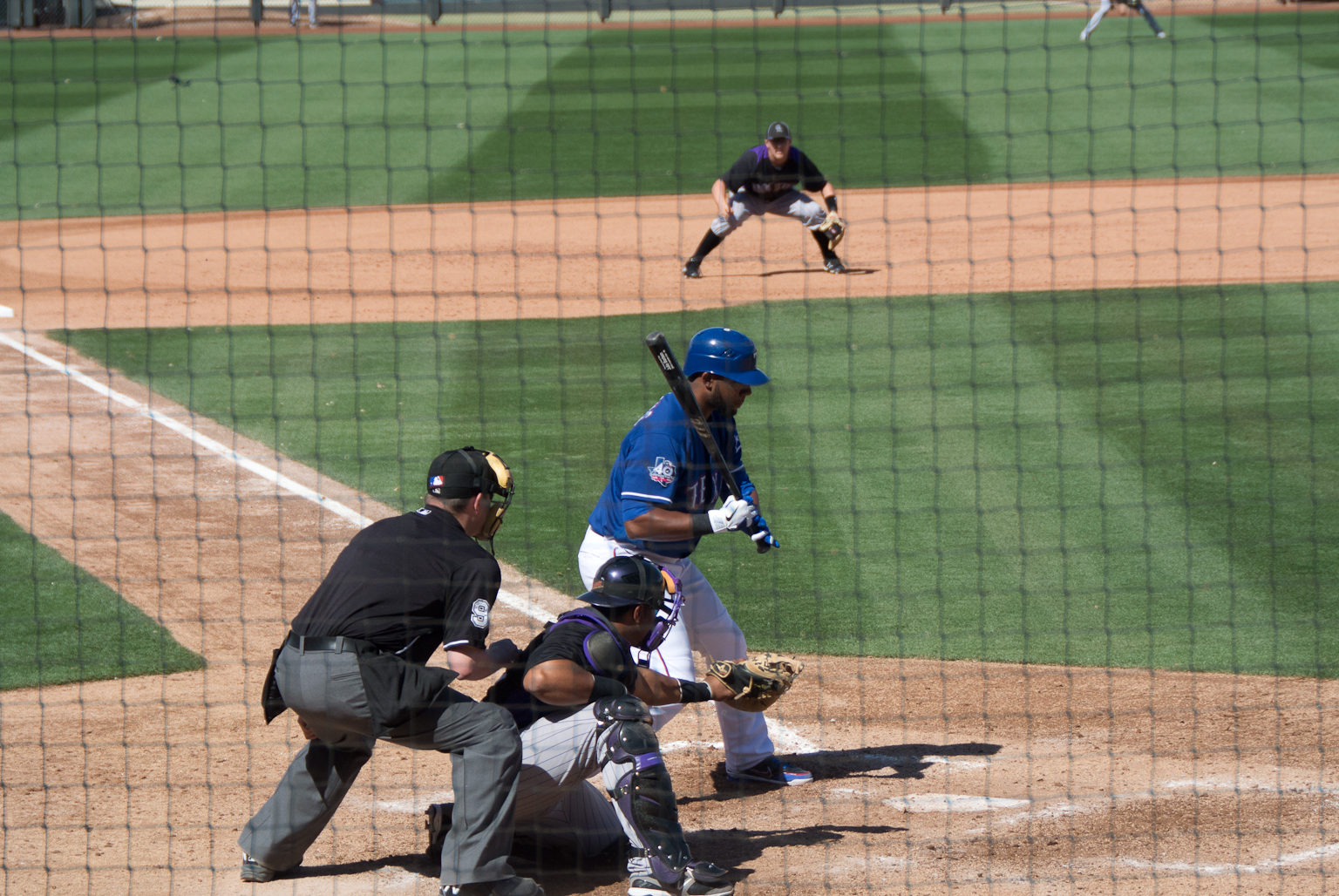 a baseball player at bat and his team mate in the background