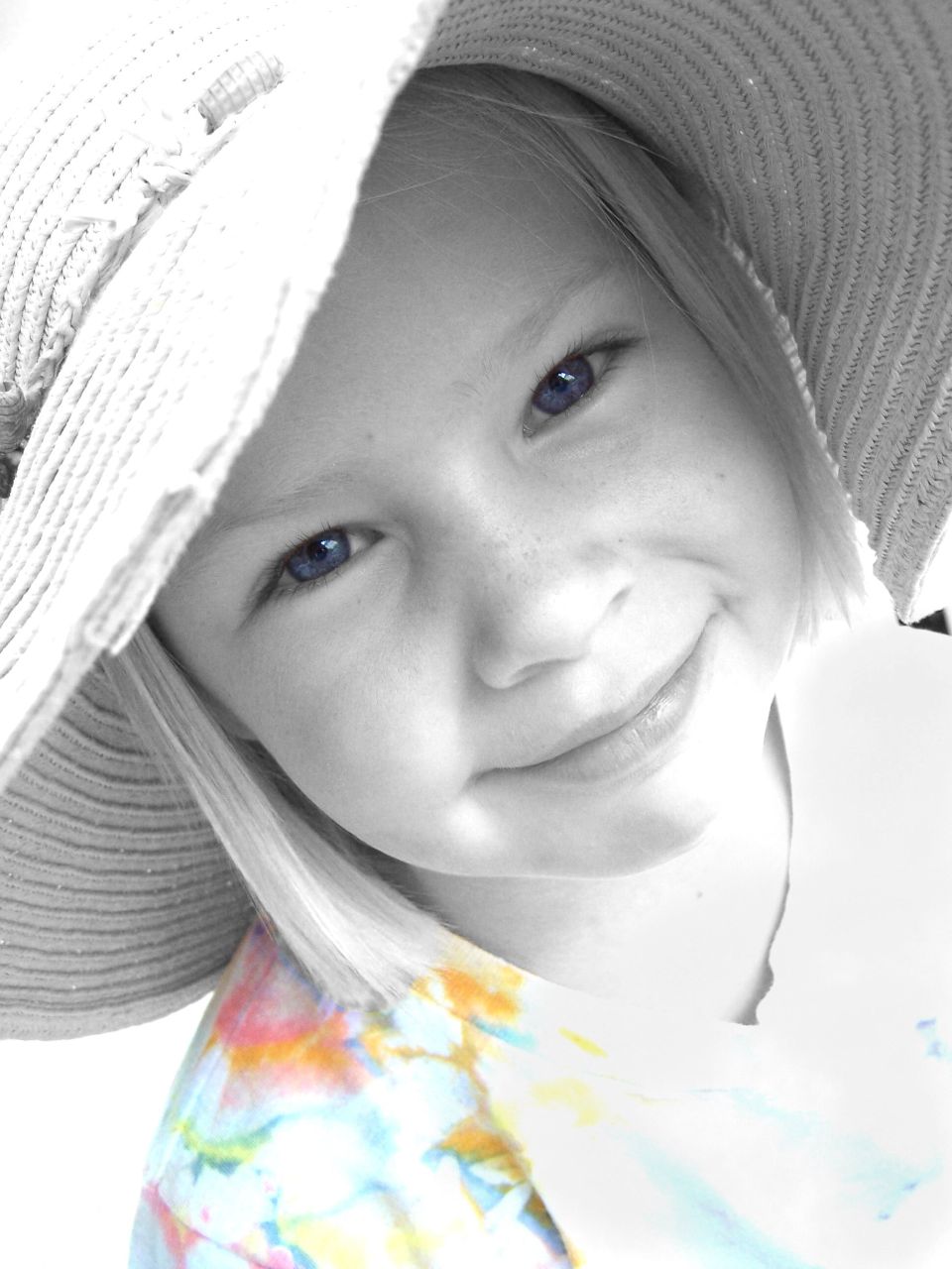 black and white pograph of a little girl wearing a sun hat