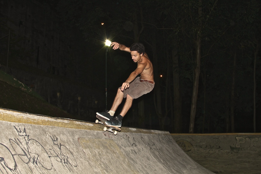 a boy on his skate board is performing tricks