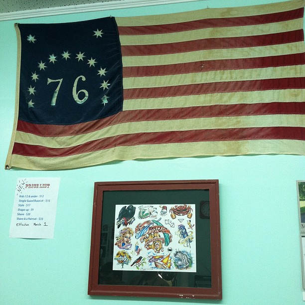 a flag hanging on the wall with another flag displayed
