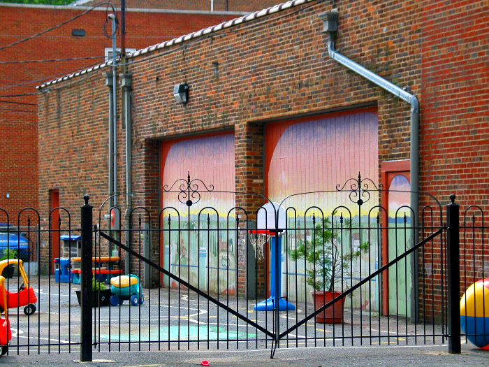 the back of a building with a basketball court