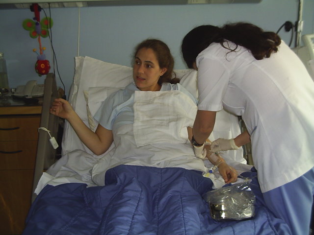 the woman is in the hospital holding her iv
