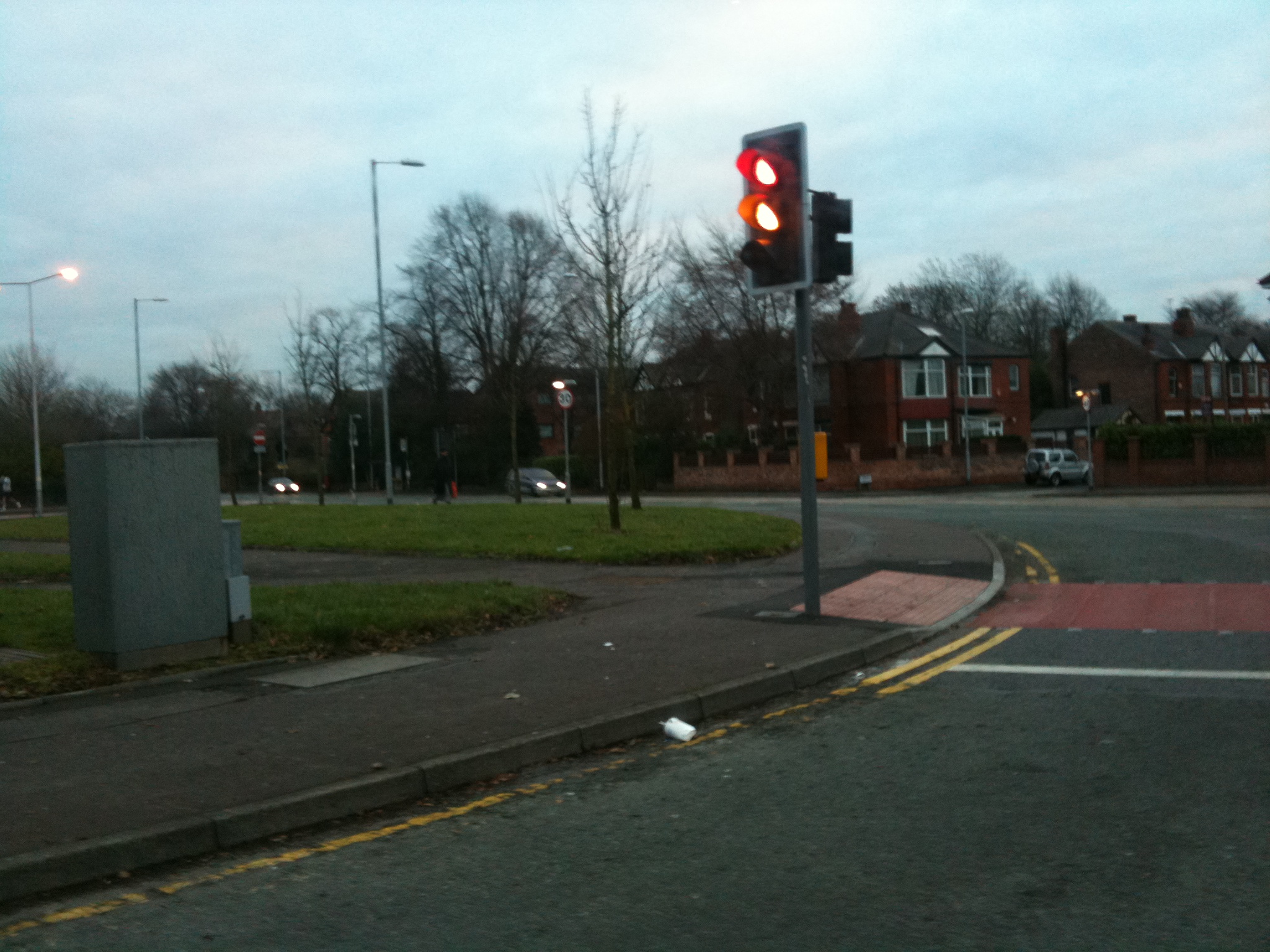 a traffic light on a pole on the side of the road