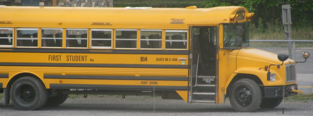 the front of a school bus that says first student