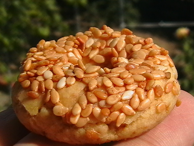 a donut with nuts and orange sauce on it