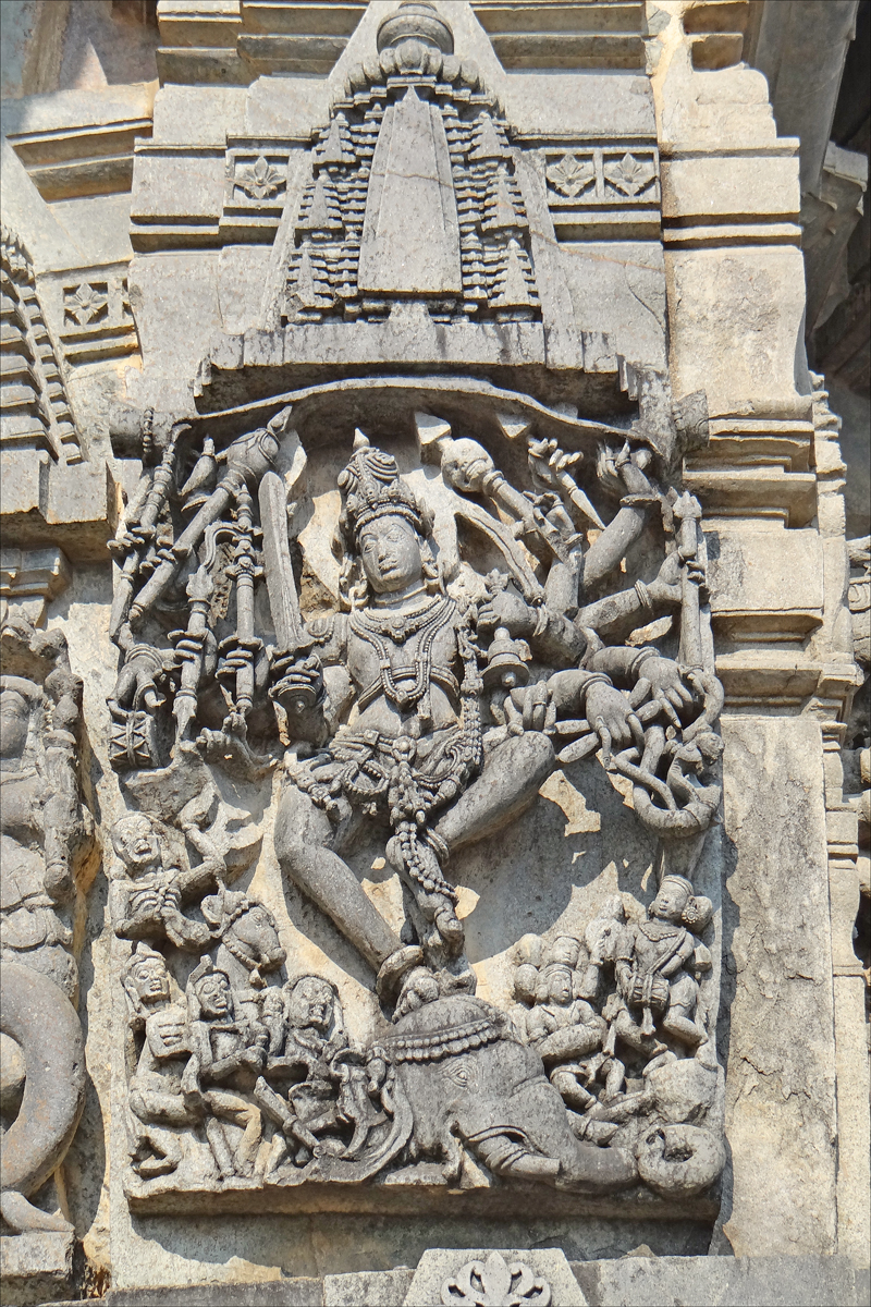 an ornate indian painting depicting god on the face of a building