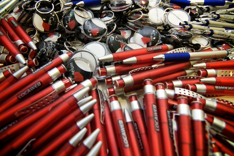 several red and white pens and many silver metal rings