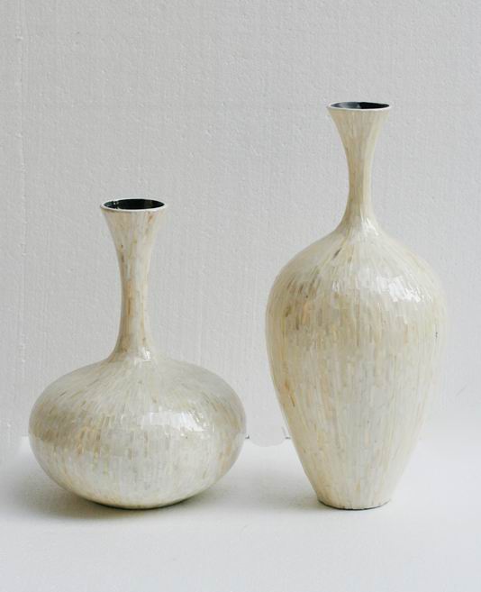 a couple of large white vases sitting on a table