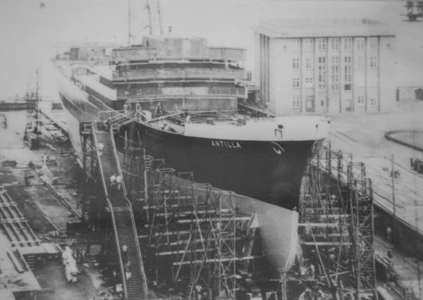 there is a huge boat docked with large ships