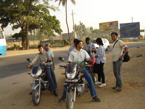 a group of people on motor bikes in the middle of the street