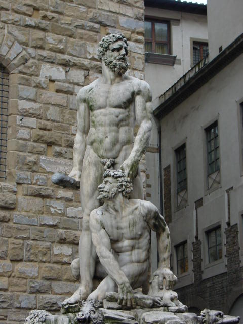 a statue of a man touching a kneeling man