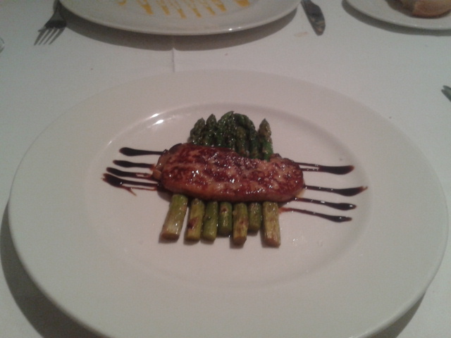 a plate topped with meat and asparagus